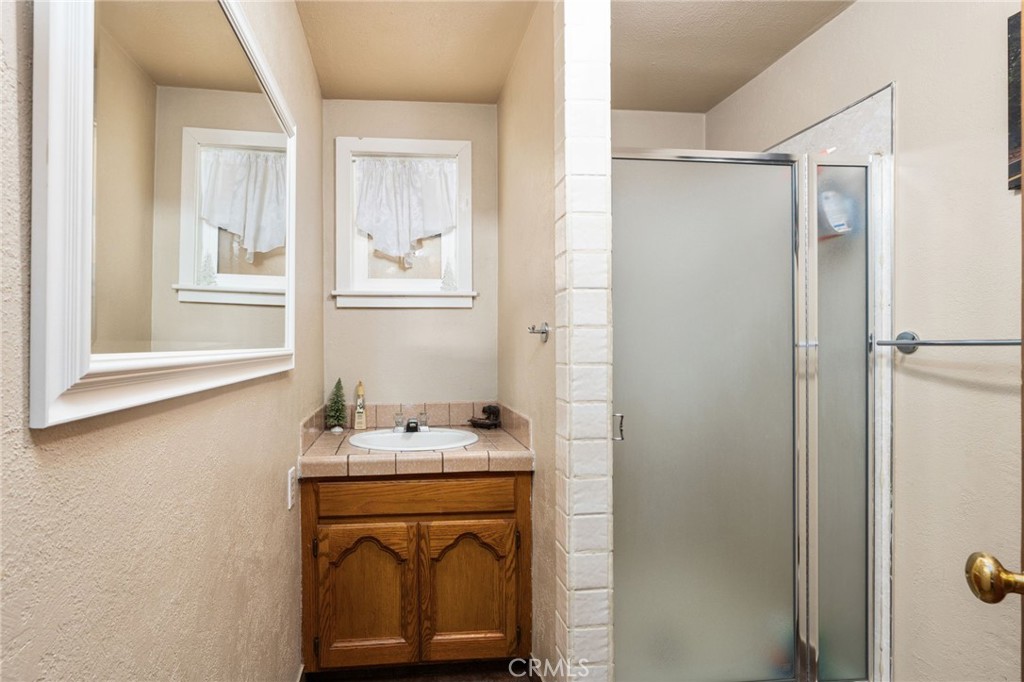 42031 North Aspen Road Shaver Lake, CA 93664 - Photo 9 of 49 a bathroom with a sink a vanity and a mirror
