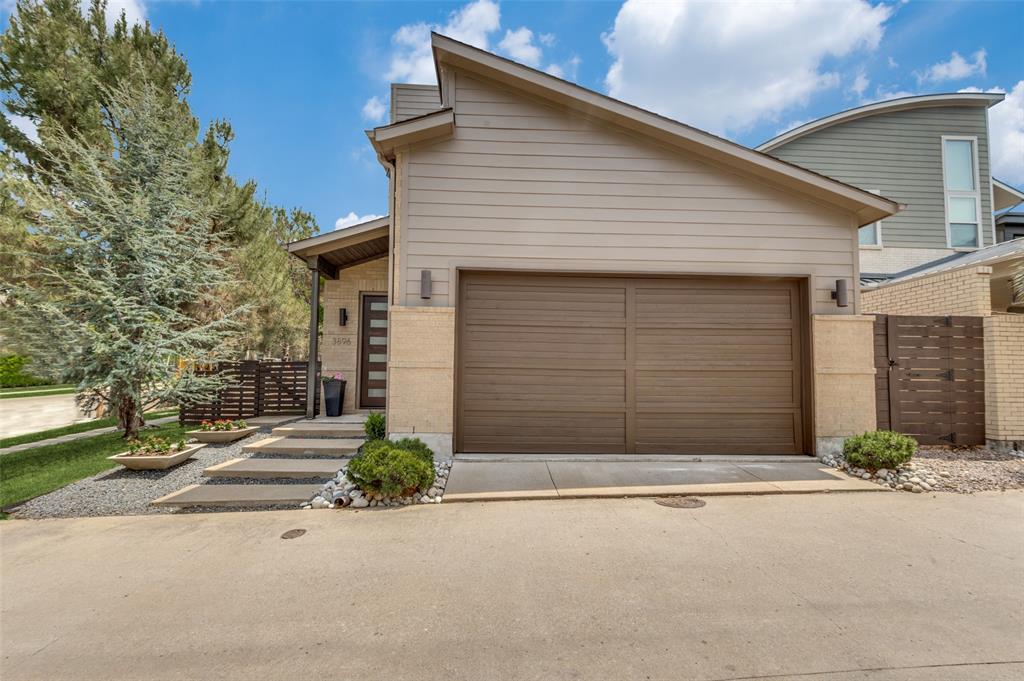 3896 Pine Tree Court Dallas, TX 75206 - Photo 1 of 1 a front view of a house with a yard and garage