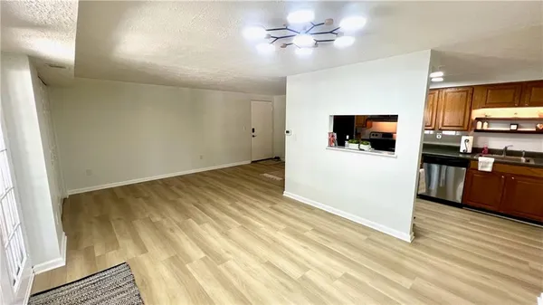 a view of a kitchen with microwave and refrigerator
