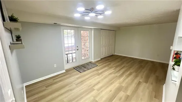 a view of empty room with window and ceiling fan