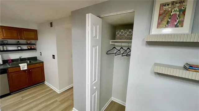 a view of a kitchen with stainless steel appliances cabinets and a wooden floor