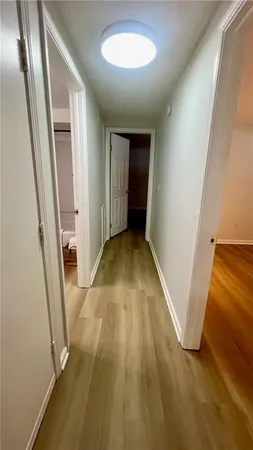an entryway of a house with wooden floor