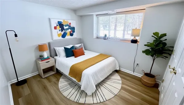 a bedroom with a bed and a window
