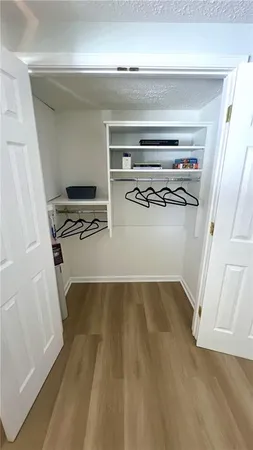 a view of a room with wooden floor