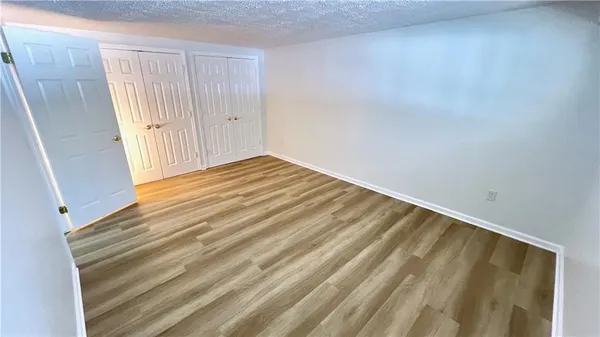 a view of a room with wooden floor and stairs