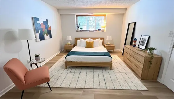 a bedroom with a bed and a large mirror on a dresser