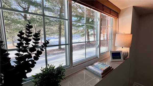 a view of a living room with furniture and a floor to ceiling window