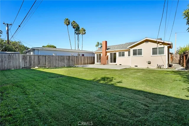 a view of a house with a yard and sitting area