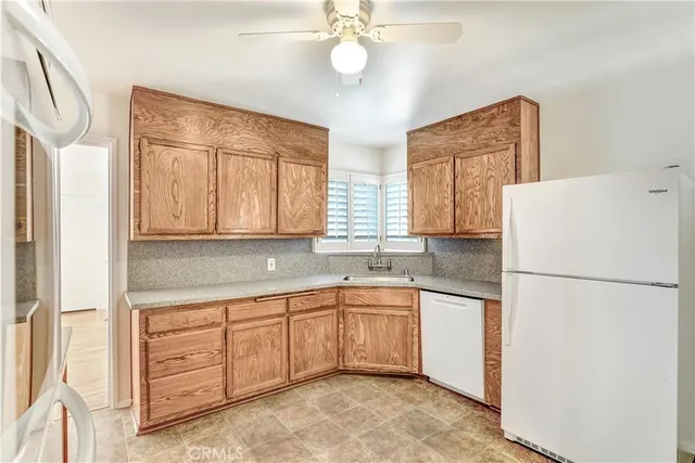 a kitchen with a refrigerator a sink and cabinets