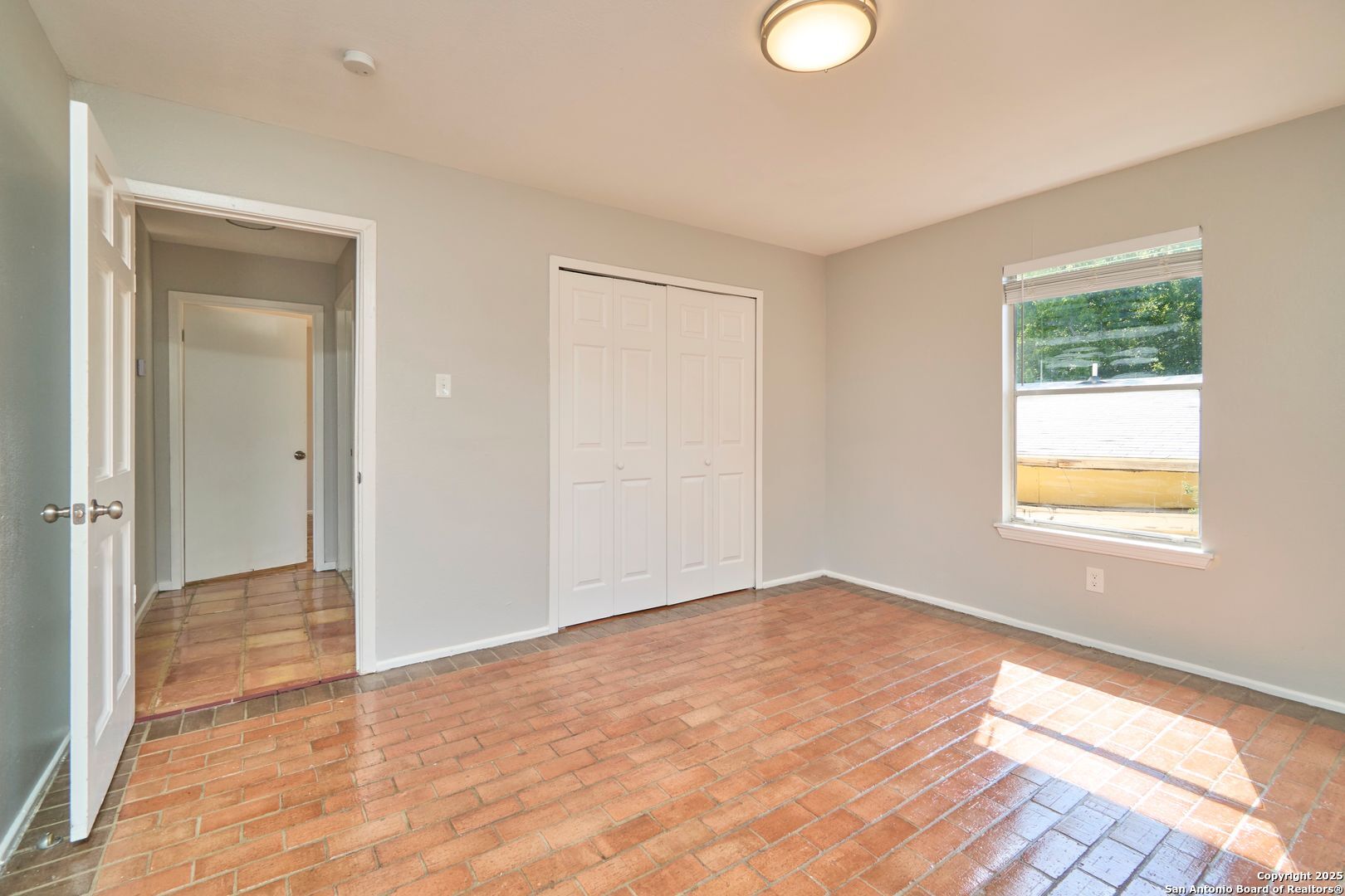 418 Verne Street, Unit 3 San Antonio, TX 78221 - Photo 13 of 21 a view of an empty room with wooden floor and a window