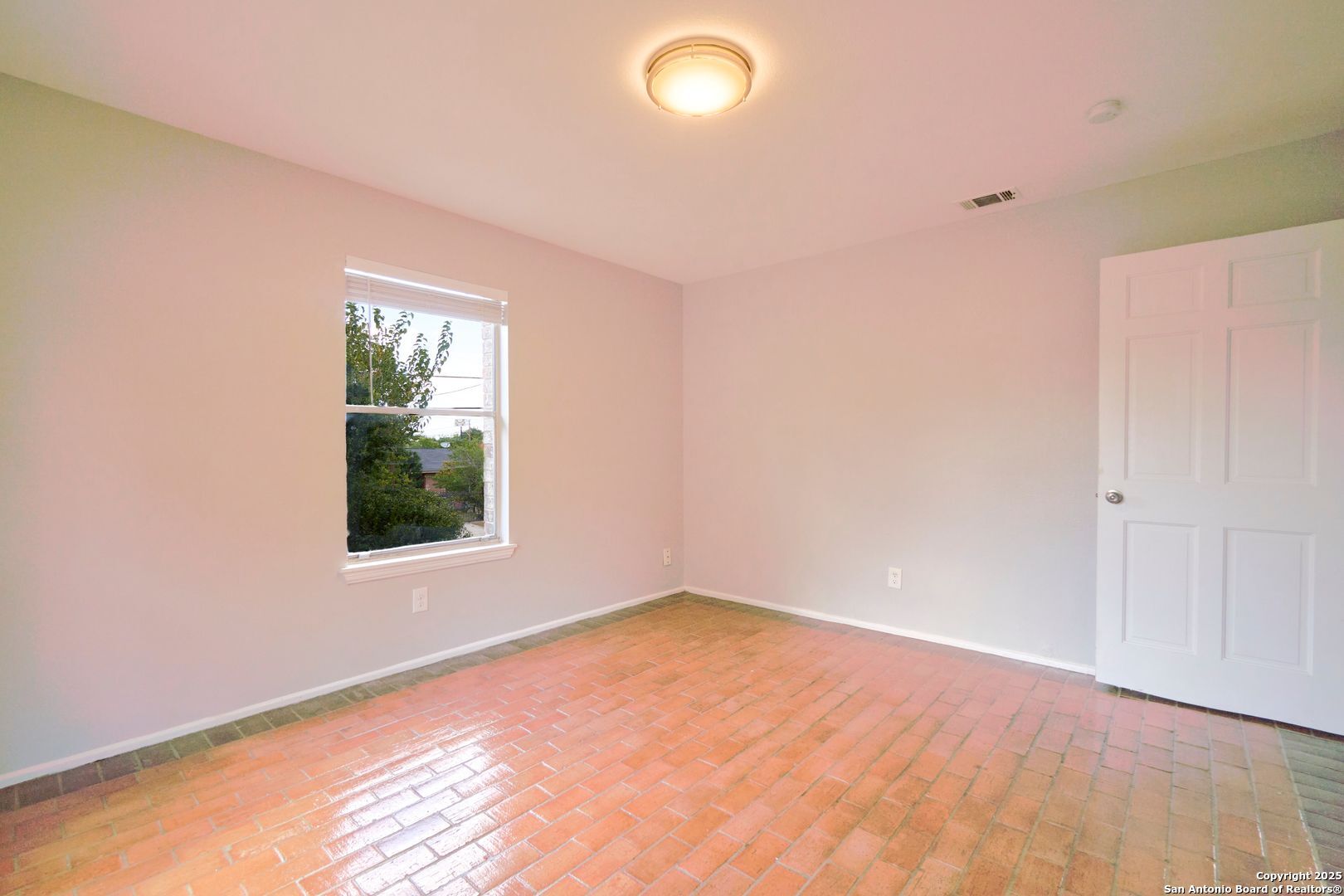 418 Verne Street, Unit 3 San Antonio, TX 78221 - Photo 14 of 21 an empty room with wooden floor and windows