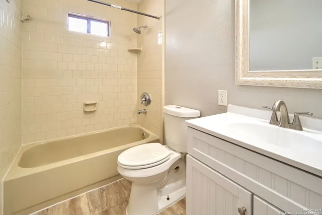 a bathroom with a toilet sink and shower