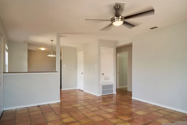 a kitchen with kitchen island a stove a sink and a window