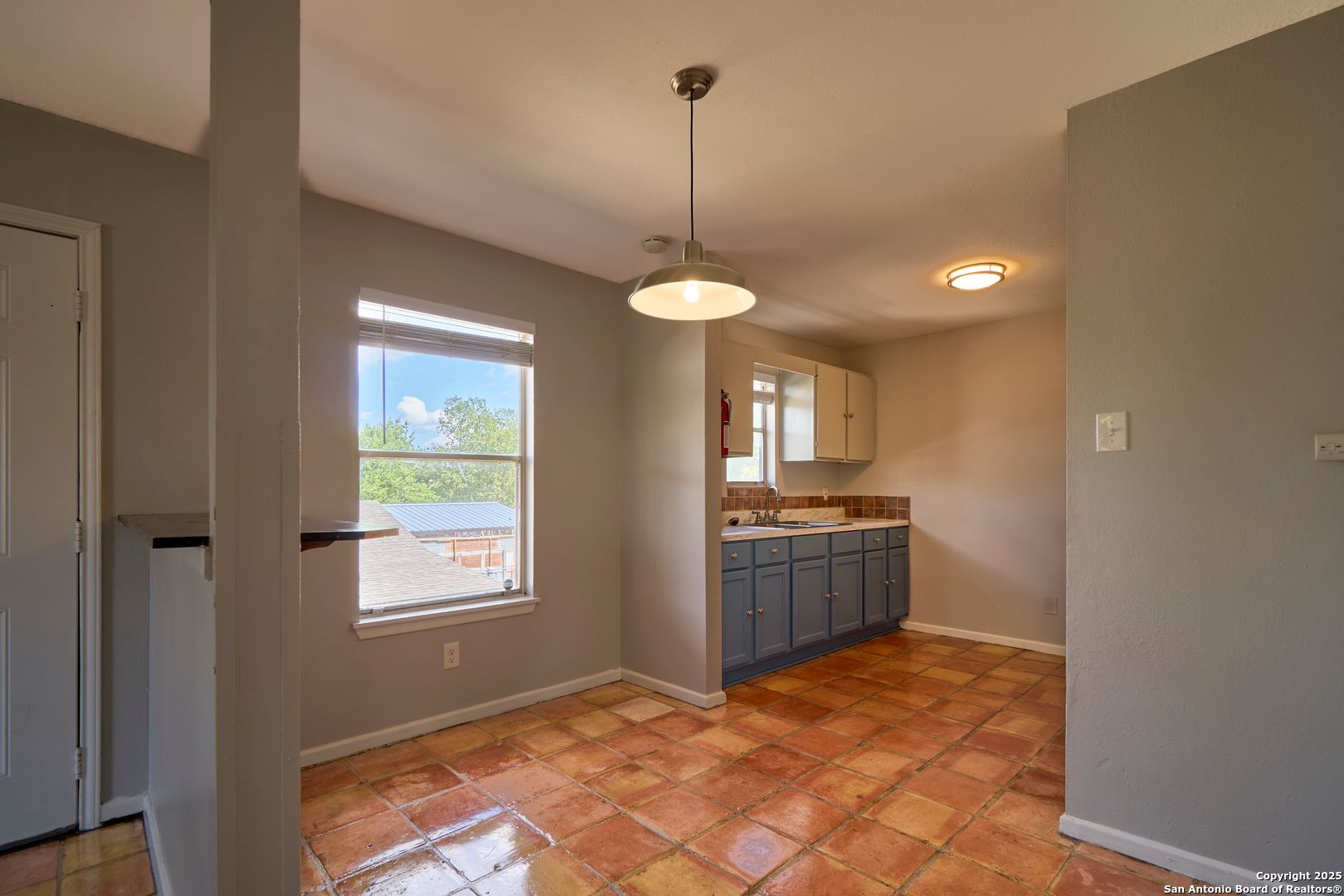 418 Verne Street, Unit 3 San Antonio, TX 78221 - Photo 7 of 21 a kitchen with kitchen island a stove a sink and a window