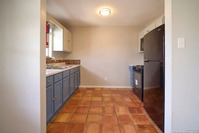 a kitchen with a sink cabinets and a window