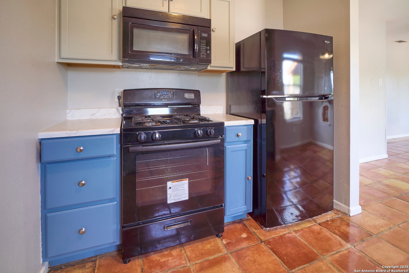 418 Verne Street, Unit 3 San Antonio, TX 78221 - Photo 10 of 21 a kitchen with granite countertop wooden cabinets and a stove top oven