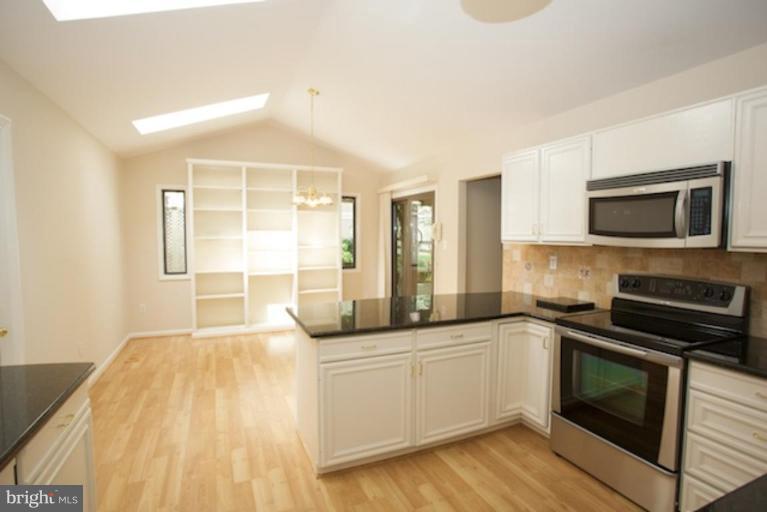 11806 Tree Fern Court Reston, VA 20191 - Photo 3 of 20 a kitchen with a sink a counter top space cabinets and stainless steel appliances