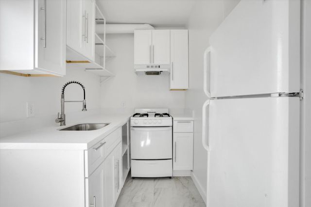 a kitchen with stainless steel appliances a sink and a refrigerator
