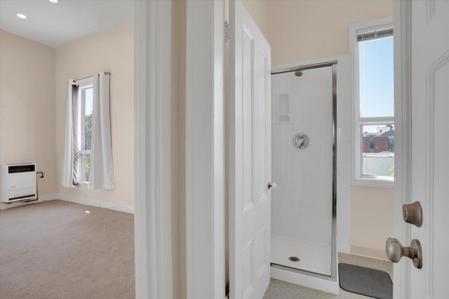 a bathroom with a sink a toilet and a window