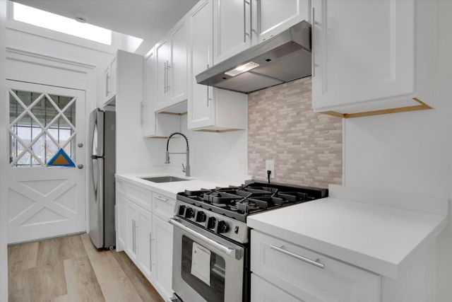 a kitchen with a stove and a microwave