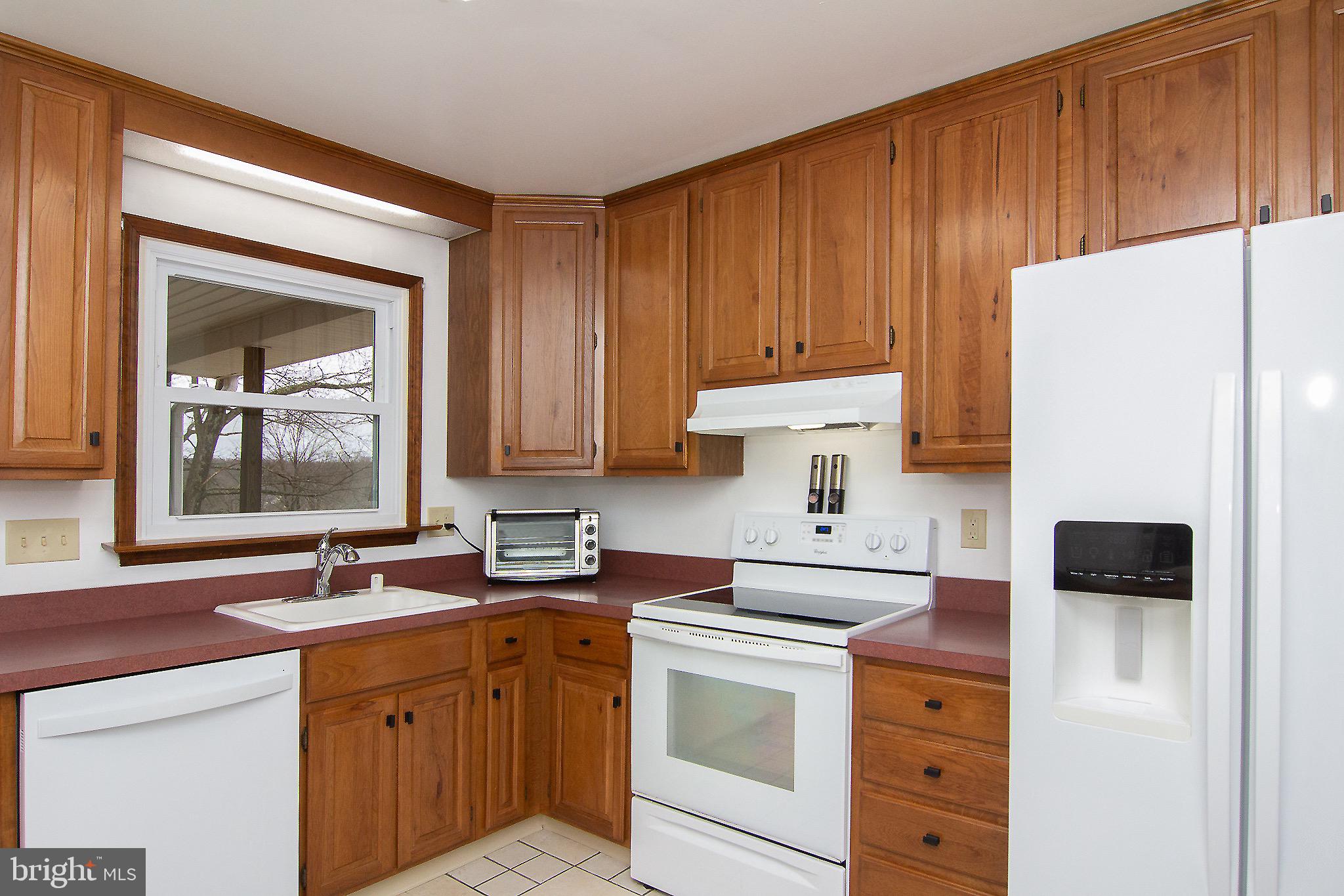 4813 Millers Station Road Hampstead, MD 21074 - Photo 11 of 32 a kitchen with a sink cabinets and stainless steel appliances
