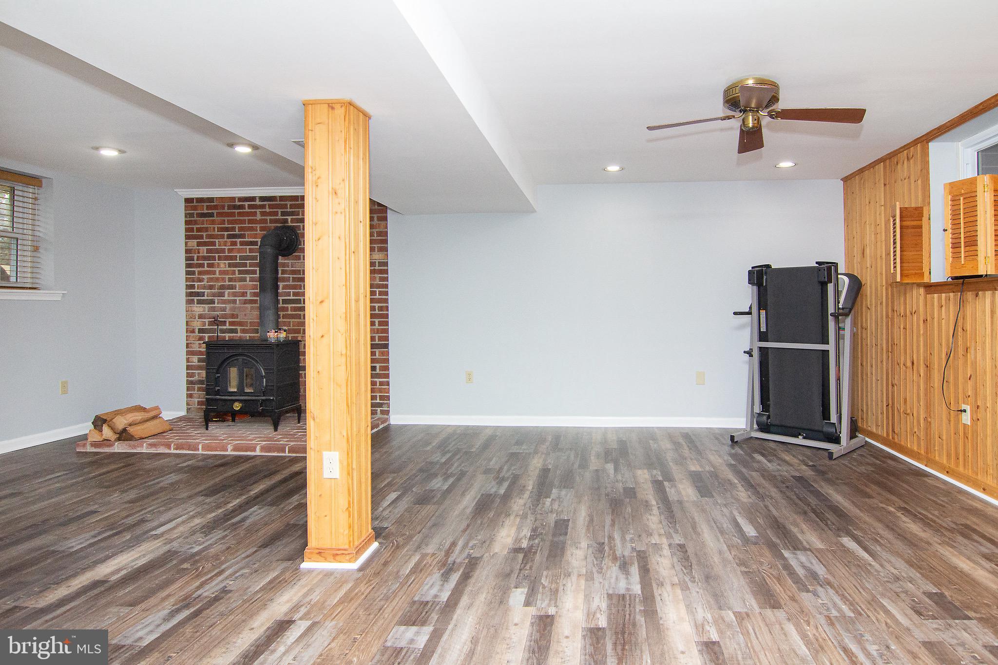 4813 Millers Station Road Hampstead, MD 21074 - Photo 13 of 32 a view of empty room with wooden floor and fan