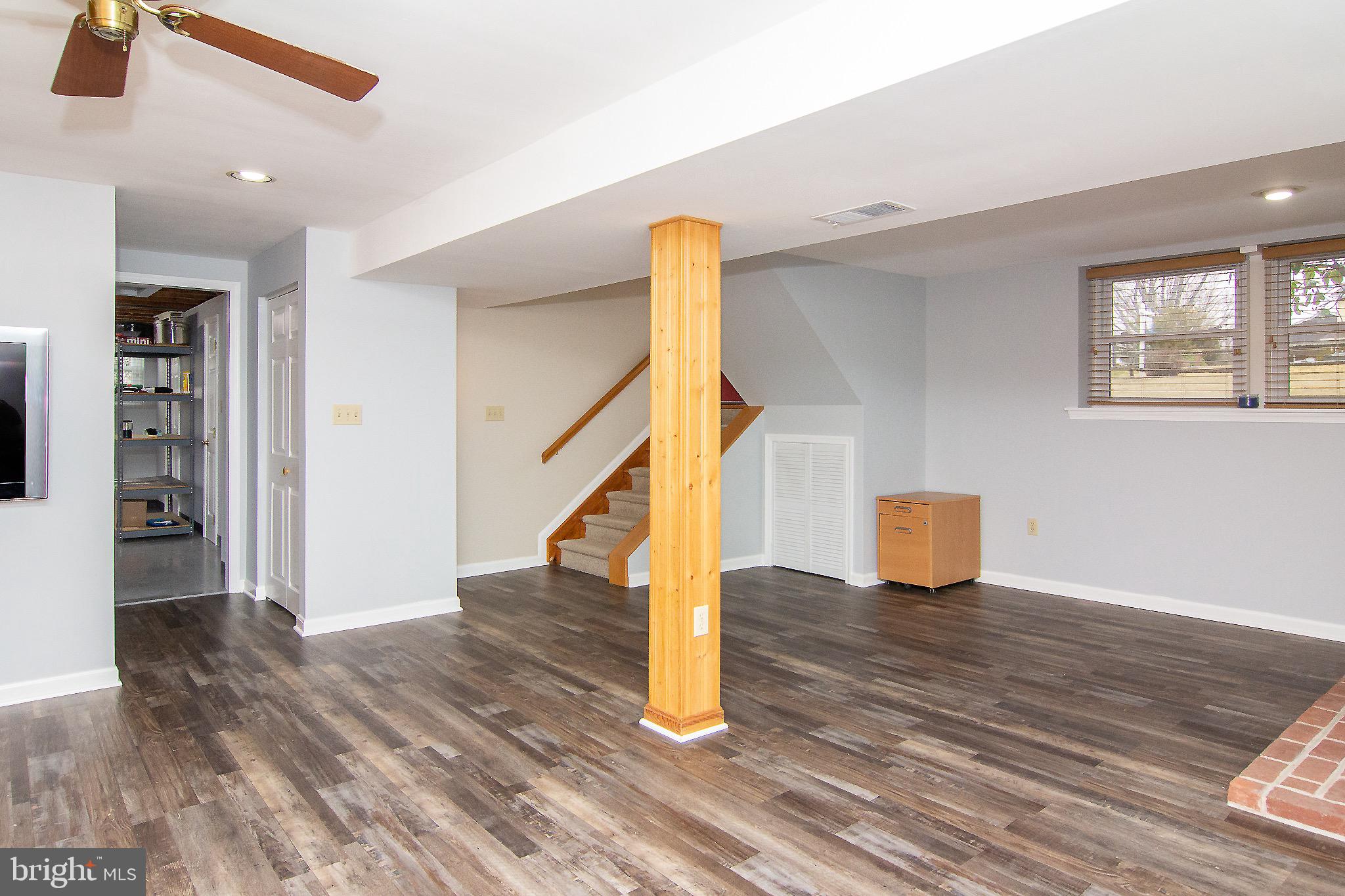 4813 Millers Station Road Hampstead, MD 21074 - Photo 14 of 32 a view of an empty room with wooden floor and a window