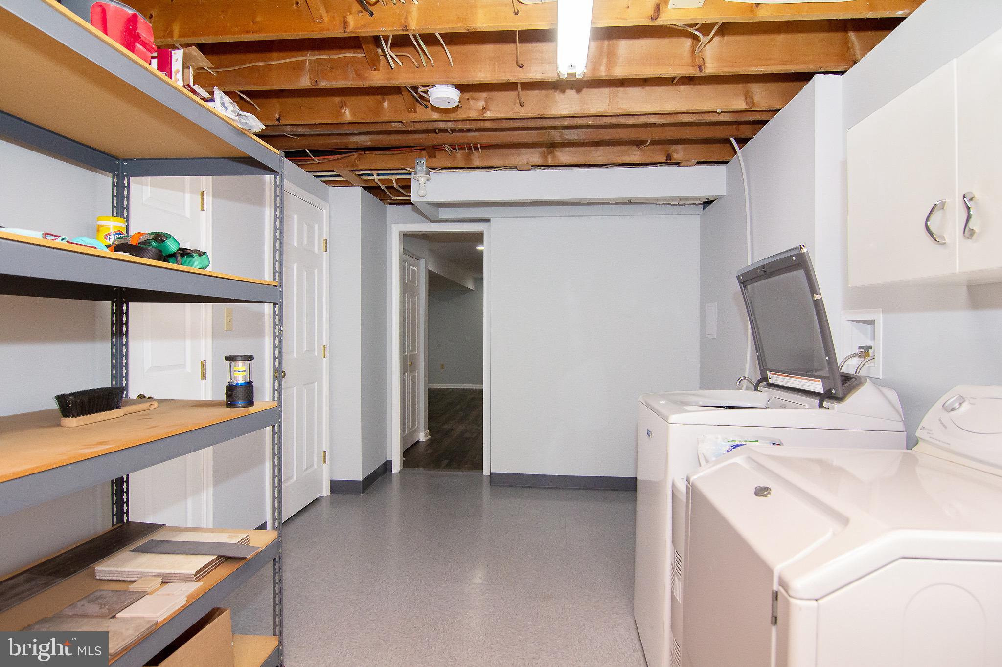 4813 Millers Station Road Hampstead, MD 21074 - Photo 16 of 32 a view of a storage & utility room with dryer and washer