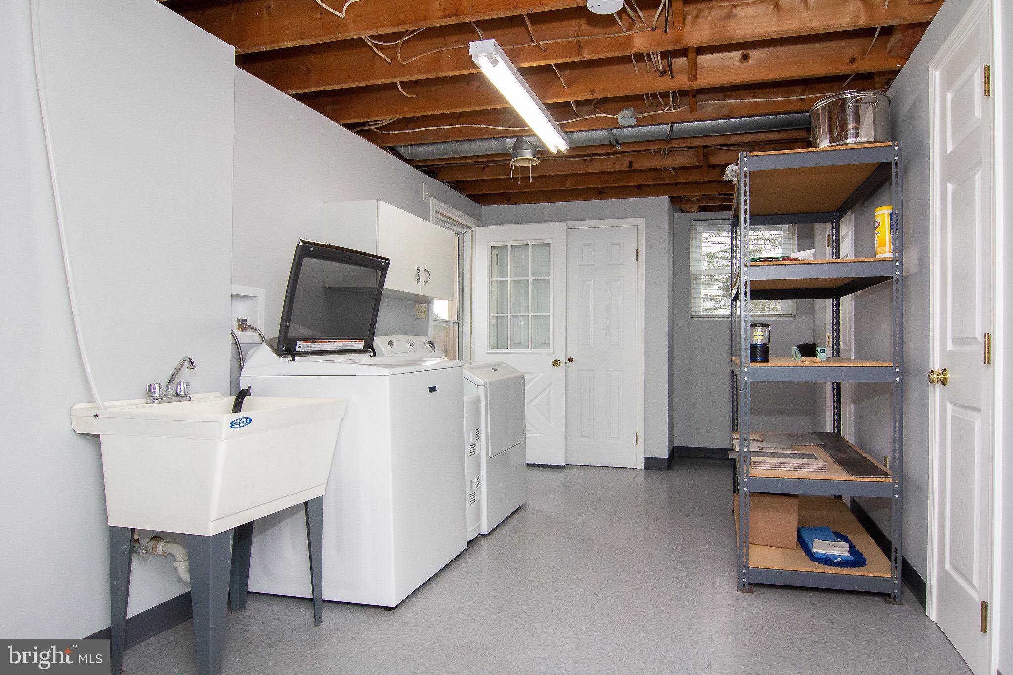 4813 Millers Station Road Hampstead, MD 21074 - Photo 17 of 32 a utility room with cabinets dryer and washer
