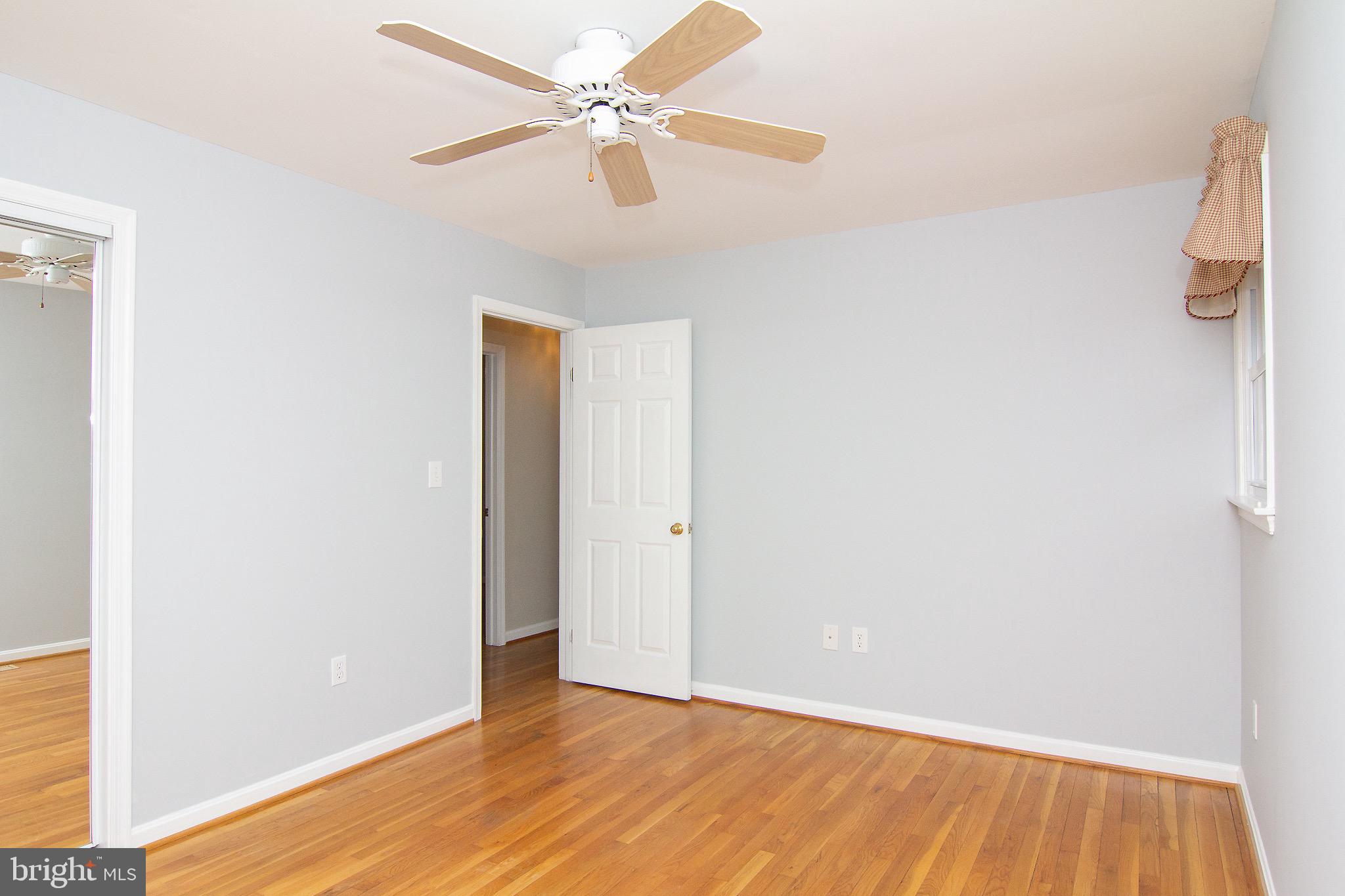 4813 Millers Station Road Hampstead, MD 21074 - Photo 19 of 32 a view of an empty room with wooden floor