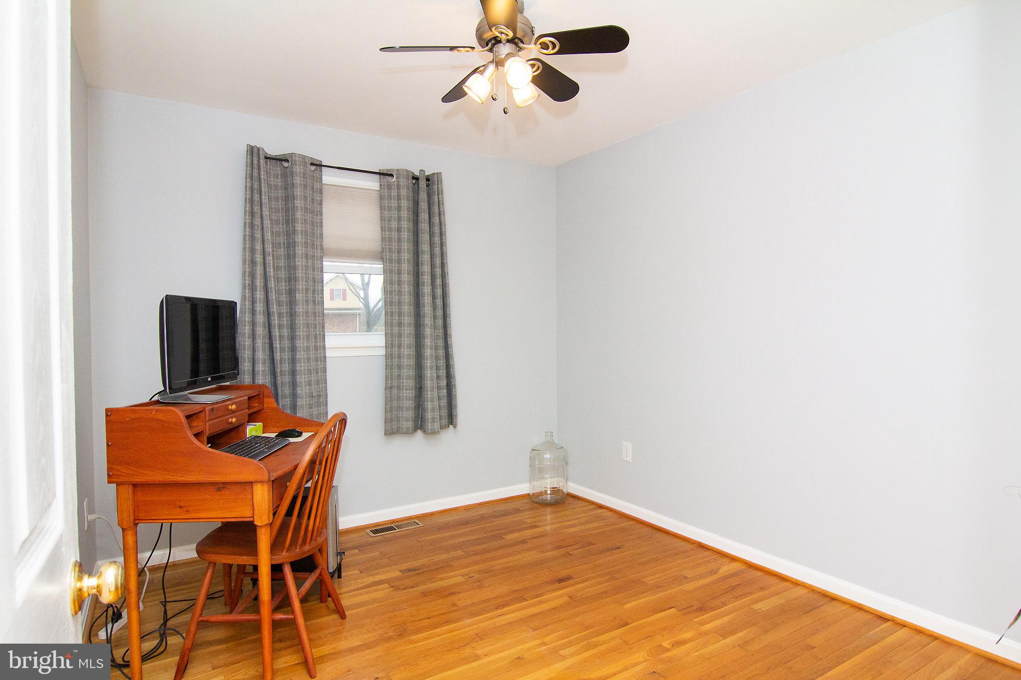 4813 Millers Station Road Hampstead, MD 21074 - Photo 20 of 32 a blue room with a window and a table