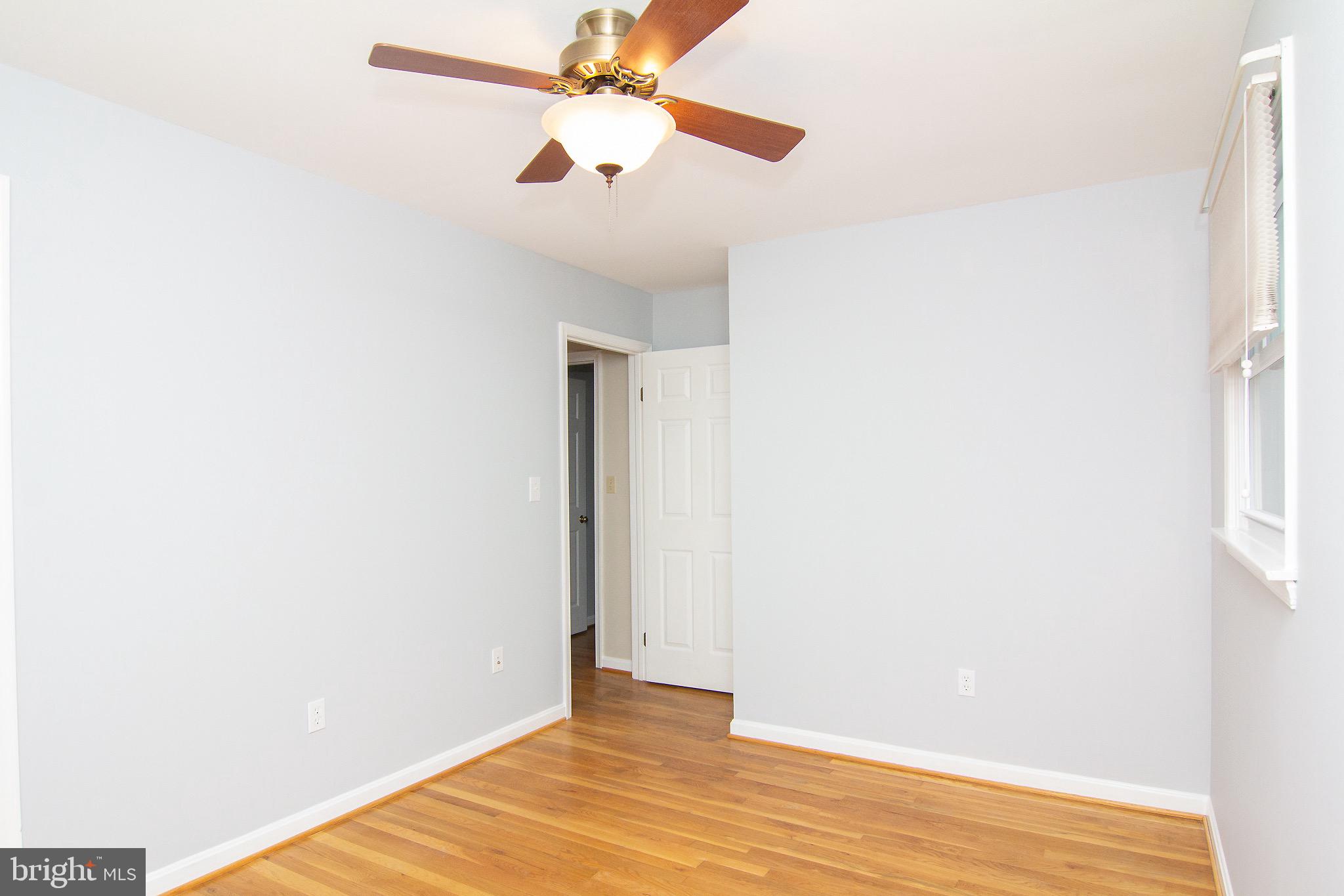 4813 Millers Station Road Hampstead, MD 21074 - Photo 23 of 32 a view of an empty room with wooden floor