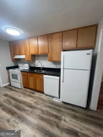 a kitchen with a stove a sink and a microwave