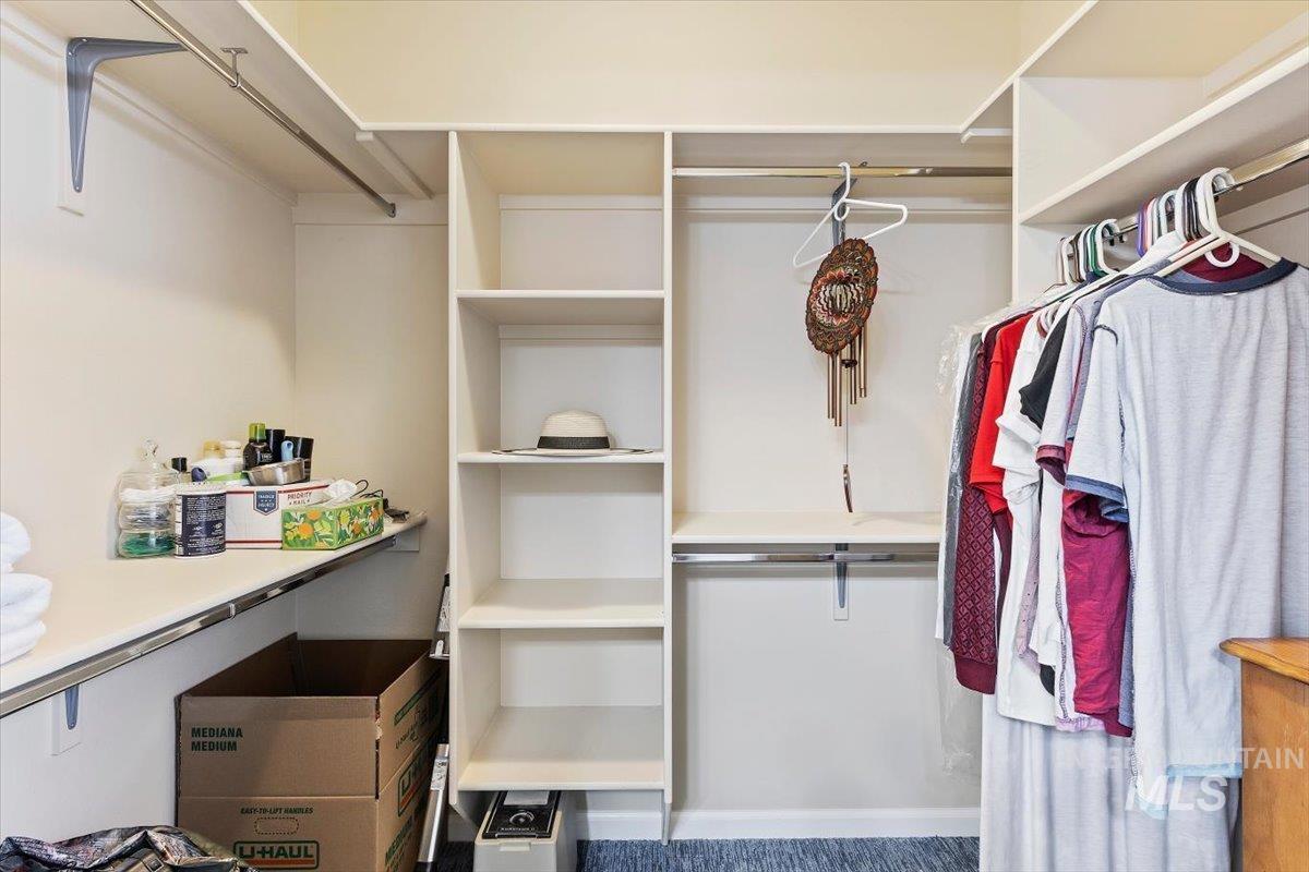 4390 North Five Mile Road Boise, ID 83704 - Photo 15 of 23 Integrated closet shelving system with multiple hanging rods and built-in compartments