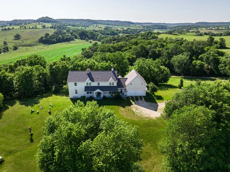 an aerial view of a house with big yard