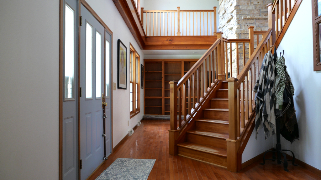 2346 West Longhollow Road Elizabeth, IL 61028 - Photo 20 of 44 a view of staircase with wooden floor and a chandelier