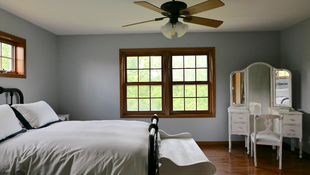 2346 West Longhollow Road Elizabeth, IL 61028 - Photo 22 of 44 a bedroom with a bed and a chandelier