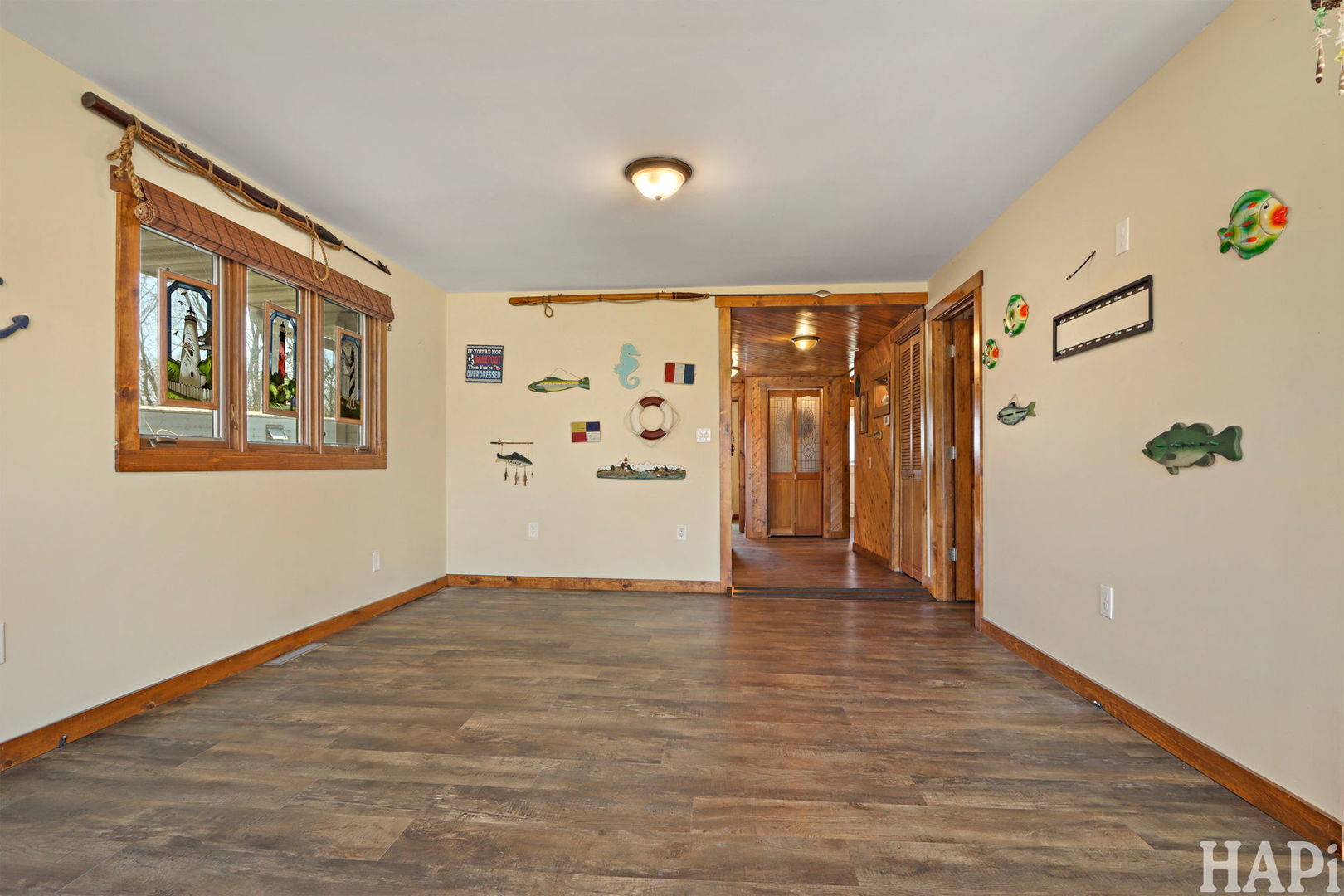 1319 Nippersink Drive Spring Grove, IL 60081 - Photo 6 of 27 a view of an empty room with wooden floor and a window