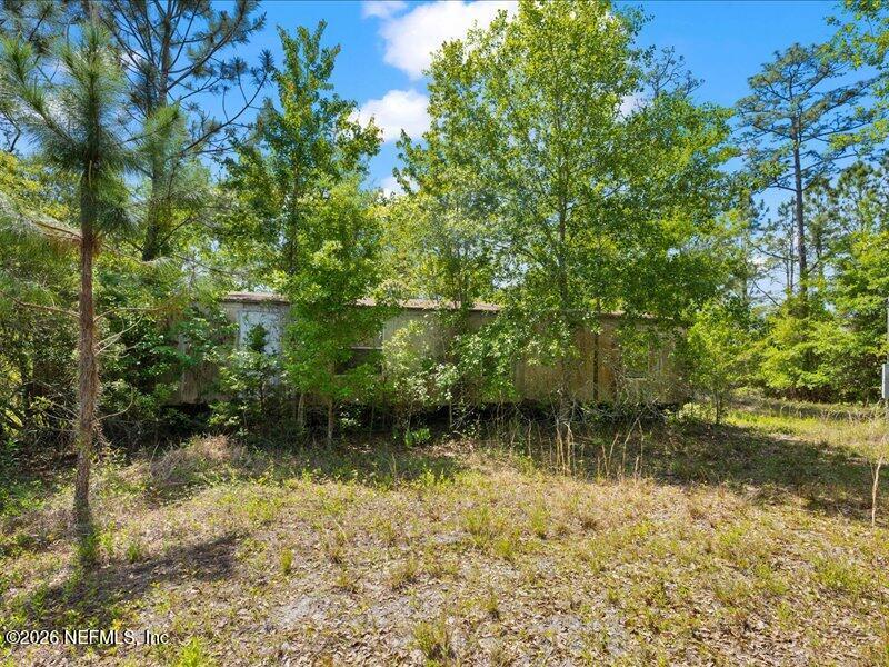5371 Church Road St. Augustine, FL 32092 - Photo 11 of 33 a backyard of a house with lots of green space and fountain