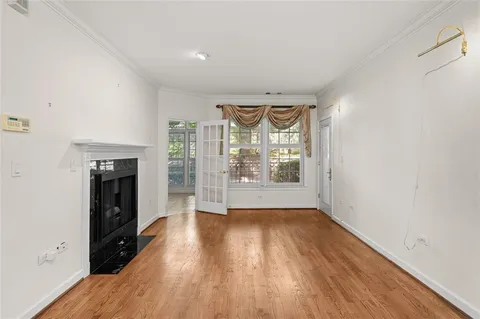 a view of empty room with wooden floor and fireplace
