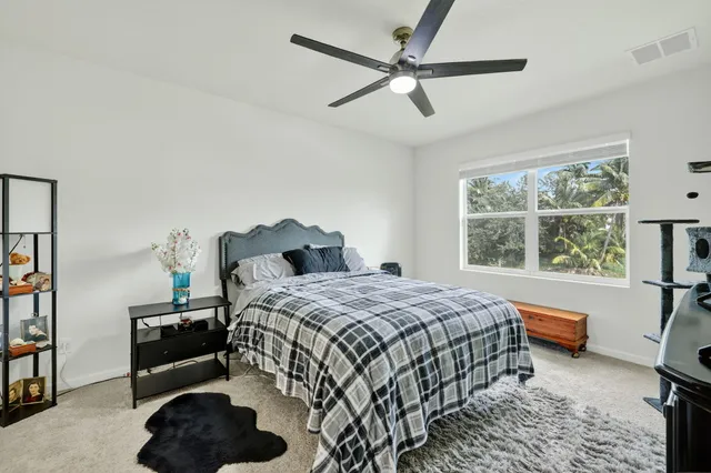 a bedroom with a bed a couch and a window