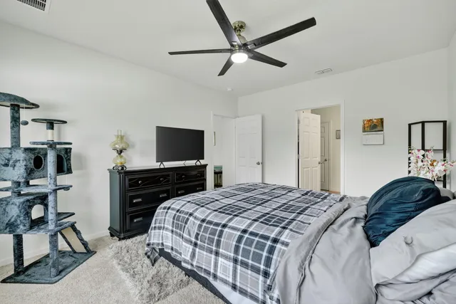 a bedroom with a bed and a flat screen tv