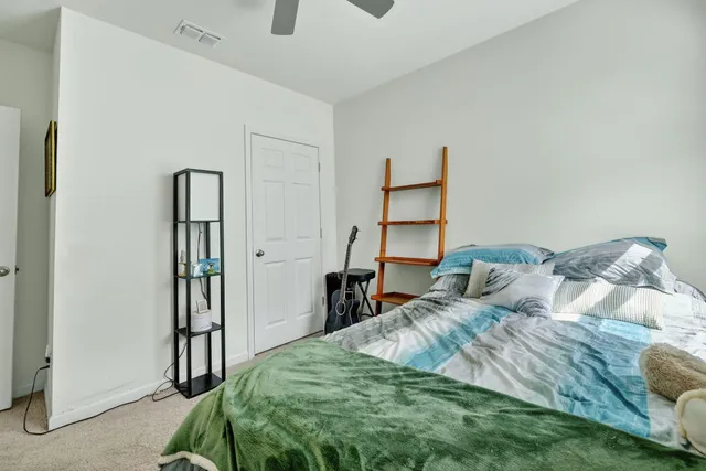 a bedroom with bed and a closet