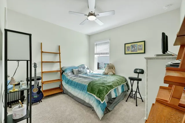 a bedroom with bed and a window