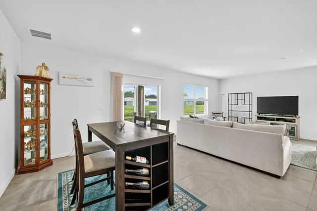 a living room with furniture a flat screen tv and a table