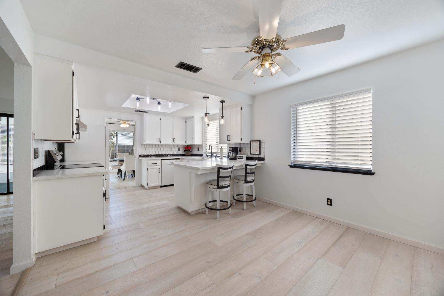 3980 Rustic Road Cameron Park, CA 95682 - Photo 14 of 42 a very nice looking room with a large window a wooden floor and a view of kitchen