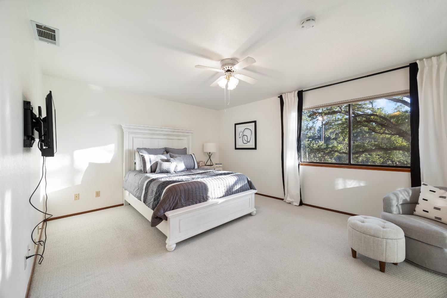 3980 Rustic Road Cameron Park, CA 95682 - Photo 17 of 42 a bedroom with furniture and a large window