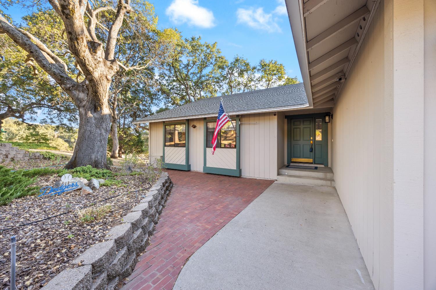 3980 Rustic Road Cameron Park, CA 95682 - Photo 33 of 42 a view of a house with a tree and plants