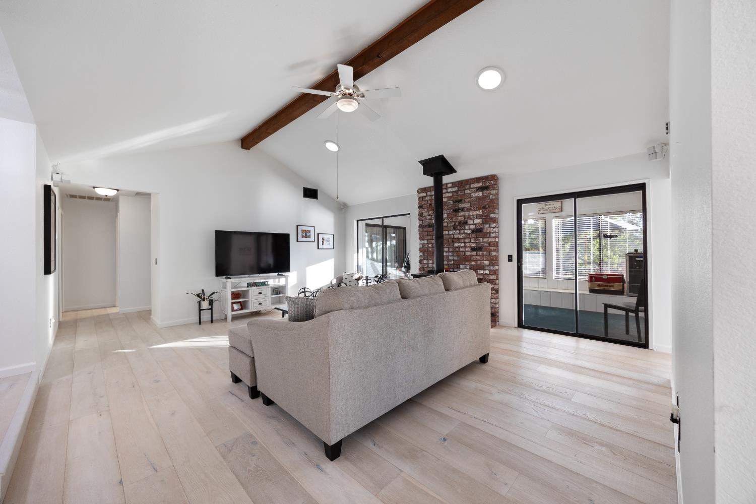 3980 Rustic Road Cameron Park, CA 95682 - Photo 9 of 42 a living room with furniture a flat screen tv and a floor to ceiling window