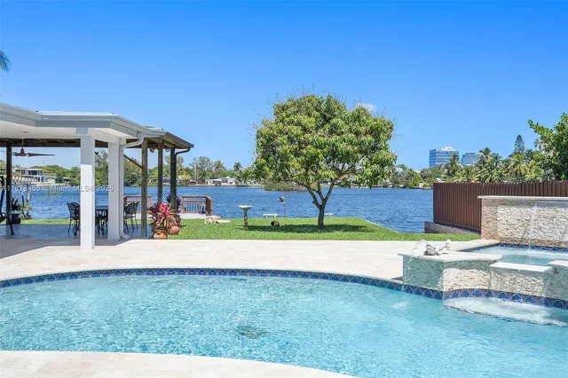 an aerial view of a house with a swimming pool patio and outdoor seating